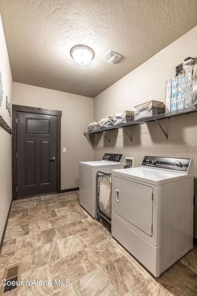 14441 N Pristine Cir, Rathdrum, ID 83858 - washroom with washer and clothes dryer and a textured ceiling