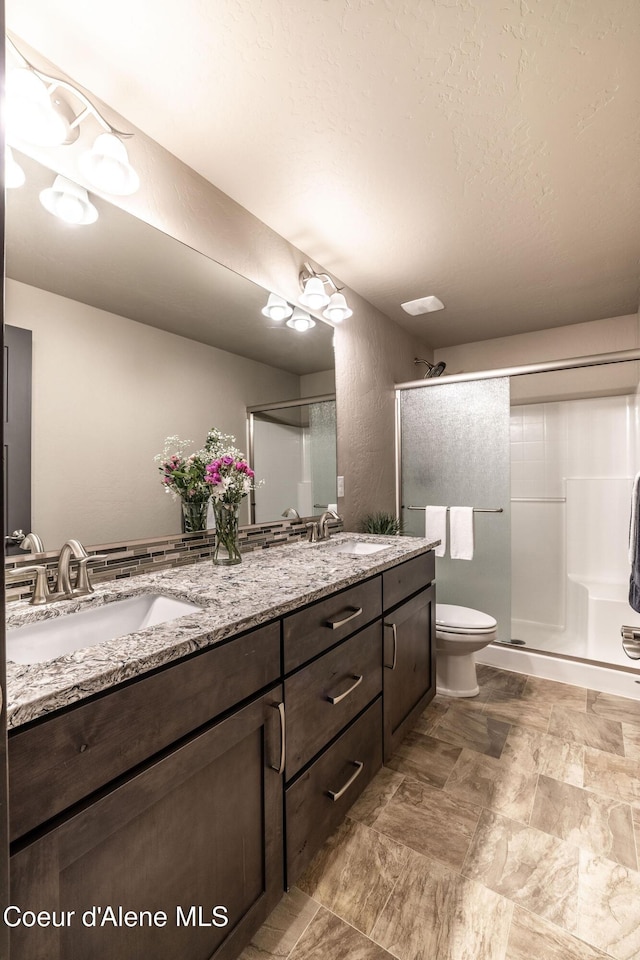 14441 N Pristine Cir, Rathdrum, ID 83858 - full bath featuring double vanity, a stall shower, and toilet
