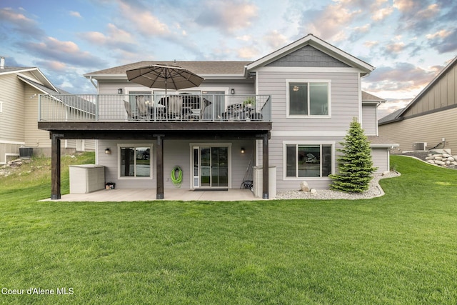 14441 N Pristine Cir, Rathdrum, ID 83858 - rear view of house with a patio area, a lawn, central air condition unit, and a shingled roof
