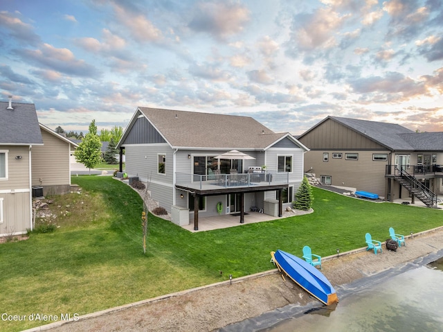 14441 N Pristine Cir, Rathdrum, ID 83858 - back of property with a patio, a deck, stairs, board and batten siding, and a yard