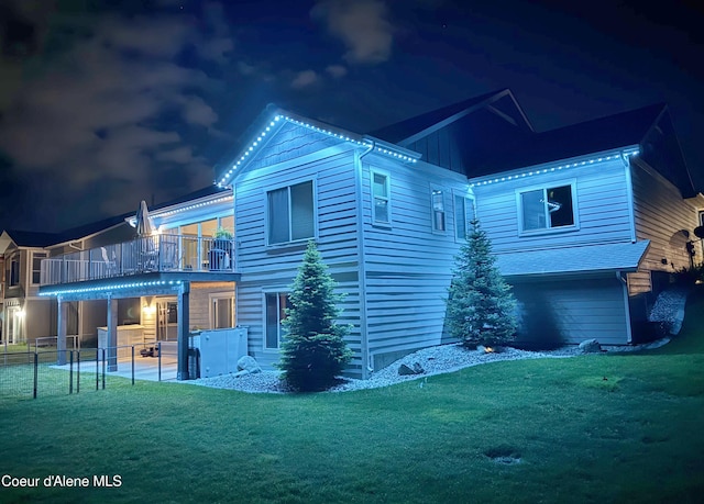 14441 N Pristine Cir, Rathdrum, ID 83858 - back of house at twilight with a balcony and a patio area