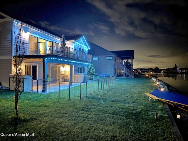 14441 N Pristine Cir, Rathdrum, ID 83858 - back of house at twilight featuring a balcony, a patio area, and a pool