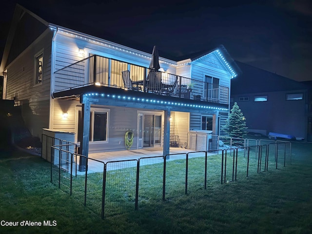 14441 N Pristine Cir, Rathdrum, ID 83858 - back of house at night featuring a balcony