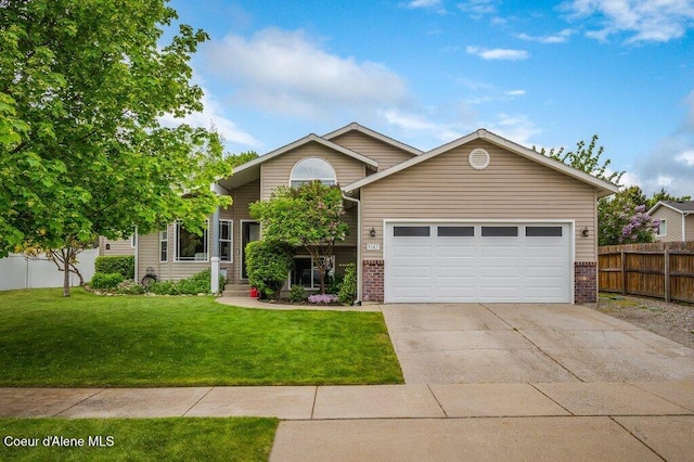 9147 N Entiate Dr, Hayden, ID 83835 - view of front facade with brick siding, driveway, and an attached garage