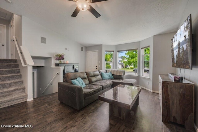 9147 N Entiate Dr, Hayden, ID 83835 - living area with dark wood-style flooring, ceiling fan, baseboards, stairway, and vaulted ceiling