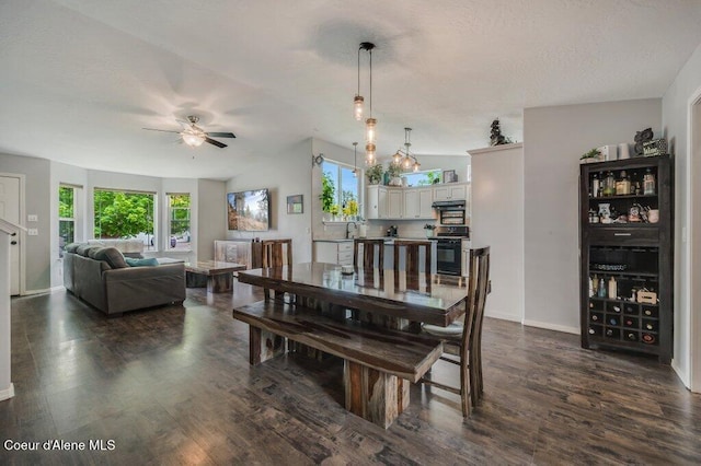 9147 N Entiate Dr, Hayden, ID 83835 - dining space with ceiling fan, dark wood-style floors, and baseboards