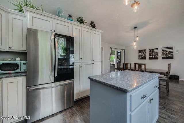 9147 N Entiate Dr, Hayden, ID 83835 - kitchen with smart refrigerator, a center island, dark wood-style floors, hanging light fixtures, and stone countertops