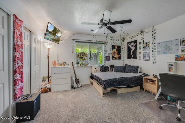 9147 N Entiate Dr, Hayden, ID 83835 - bedroom with carpet, a textured ceiling, and a ceiling fan