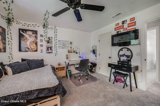 9147 N Entiate Dr, Hayden, ID 83835 - bedroom featuring carpet floors, a desk, and a ceiling fan