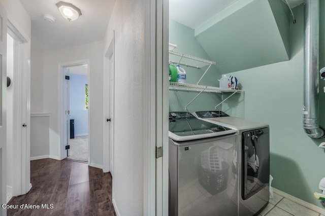 9147 N Entiate Dr, Hayden, ID 83835 - laundry room with washer and dryer, wood finished floors, and baseboards