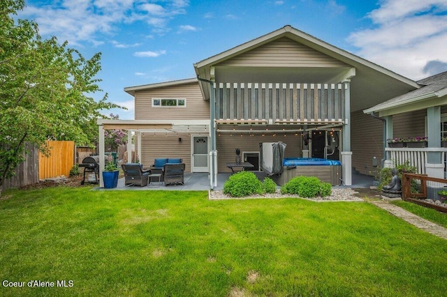 9147 N Entiate Dr, Hayden, ID 83835 - back of house featuring a hot tub, a patio area, and an outdoor living space