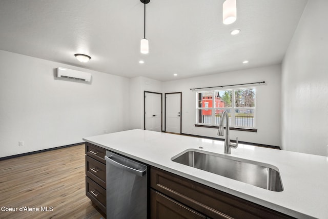 2248 N Syringa St, Post Falls, ID 83854 - kitchen with stainless steel dishwasher, a sink, a wall unit AC, light wood-type flooring, and light countertops