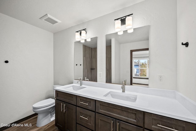 2248 N Syringa St, Post Falls, ID 83854 - full bathroom with wood finished floors, double vanity, and toilet