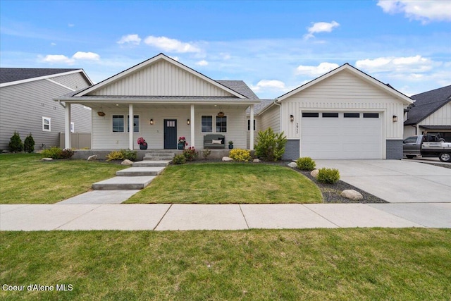 2917 N Bygone Way, Post Falls, ID 83854 - view of front of house with board and batten siding, concrete driveway, a garage, and a front lawn
