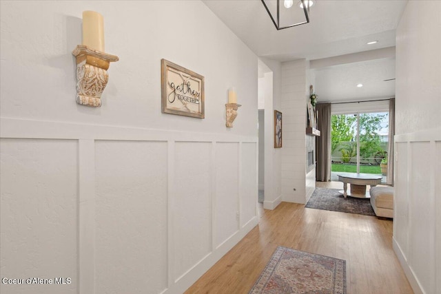 2917 N Bygone Way, Post Falls, ID 83854 - corridor with light wood-style flooring, a wainscoted wall, and a decorative wall