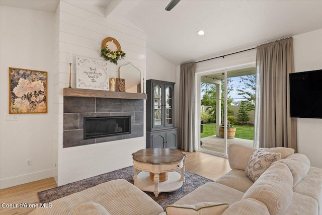 2917 N Bygone Way, Post Falls, ID 83854 - living area with light wood-style floors, a tiled fireplace, baseboards, and recessed lighting