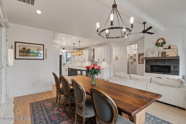 2917 N Bygone Way, Post Falls, ID 83854 - dining room featuring a chandelier, light wood-style floors, baseboards, and a tiled fireplace