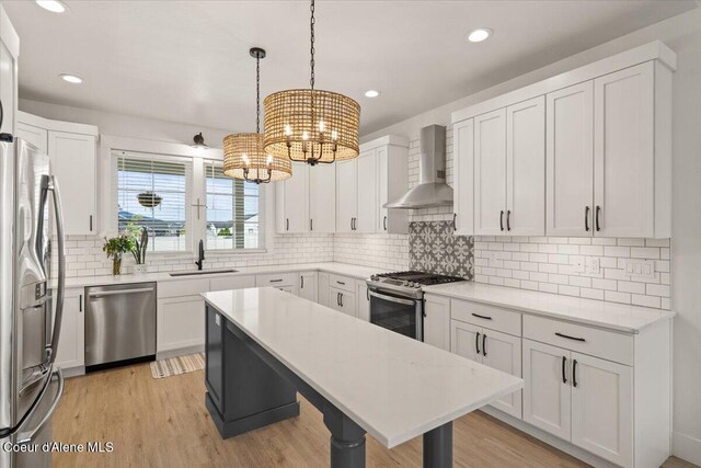2917 N Bygone Way, Post Falls, ID 83854 - kitchen featuring appliances with stainless steel finishes, wall chimney exhaust hood, a sink, a chandelier, and recessed lighting