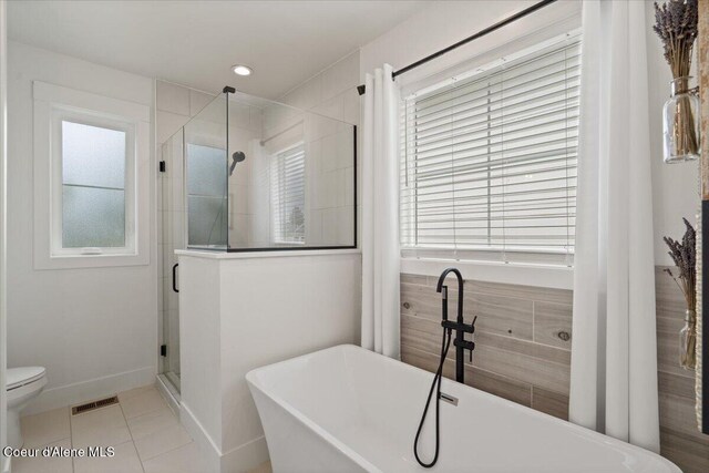 2917 N Bygone Way, Post Falls, ID 83854 - bathroom with a shower stall, healthy amount of natural light, tile patterned flooring, a soaking tub, and recessed lighting