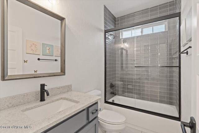 2917 N Bygone Way, Post Falls, ID 83854 - bathroom featuring toilet, vanity, and combined bath / shower with glass door