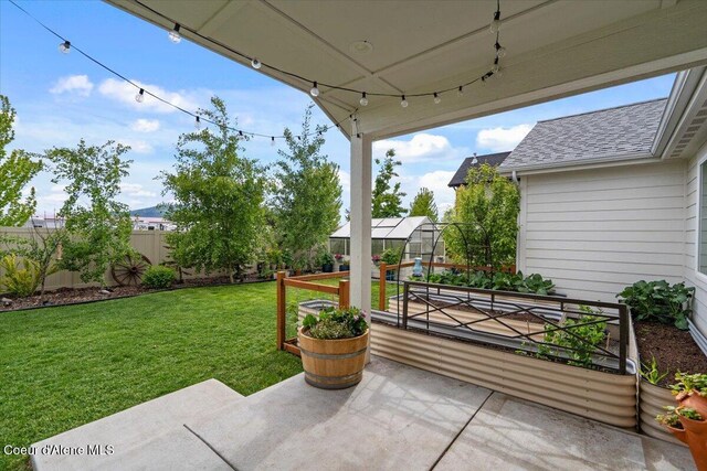 2917 N Bygone Way, Post Falls, ID 83854 - view of patio / terrace featuring a greenhouse and an outbuilding