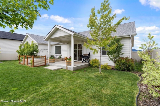 2917 N Bygone Way, Post Falls, ID 83854 - rear view of property featuring a patio area, a shingled roof, and a garden