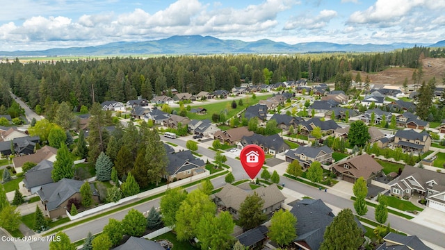 1044 E Maroon Creek Dr, Hayden, ID 83835 - aerial perspective of suburban area featuring a forest and mountains