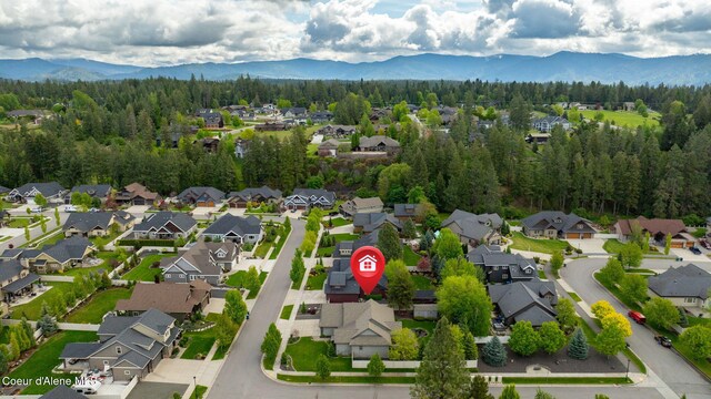 1044 E Maroon Creek Dr, Hayden, ID 83835 - aerial view of residential area featuring mountains and a heavily wooded area