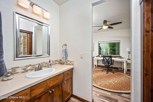 1044 E Maroon Creek Dr, Hayden, ID 83835 - bathroom with wood finished floors, vanity, a ceiling fan, and baseboards