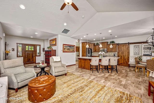 1044 E Maroon Creek Dr, Hayden, ID 83835 - living area featuring a barn door, vaulted ceiling, ceiling fan, recessed lighting, and light wood finished floors