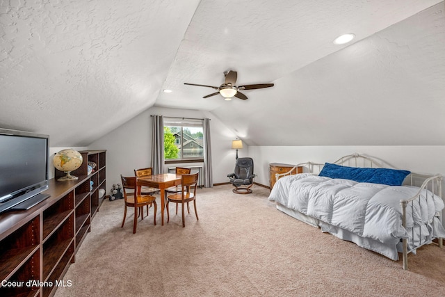1044 E Maroon Creek Dr, Hayden, ID 83835 - bedroom with a textured ceiling, lofted ceiling, carpet floors, a ceiling fan, and baseboards