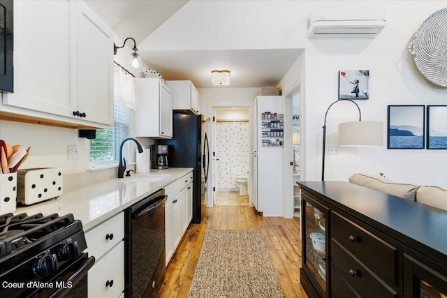 199 Pomrankey Ln, Dover, ID 83825 - kitchen with black appliances, white cabinets, light wood-style flooring, beverage cooler, and a sink