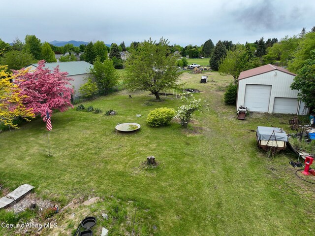8705 N Ramsey Rd, Hayden, ID 83835 - view of green lawn featuring a detached garage and an outdoor structure