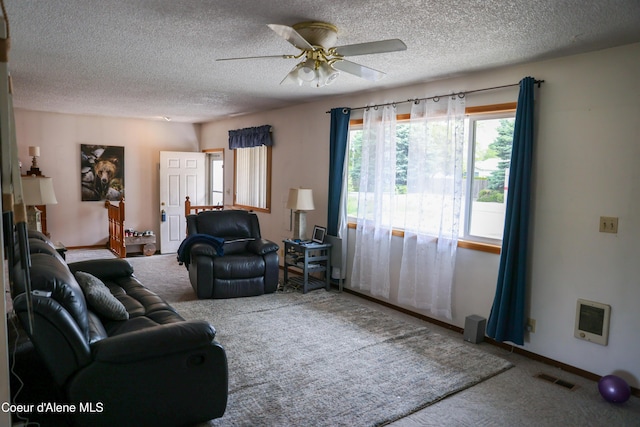 8705 N Ramsey Rd, Hayden, ID 83835 - living area with carpet flooring, a ceiling fan, a textured ceiling, and heating unit