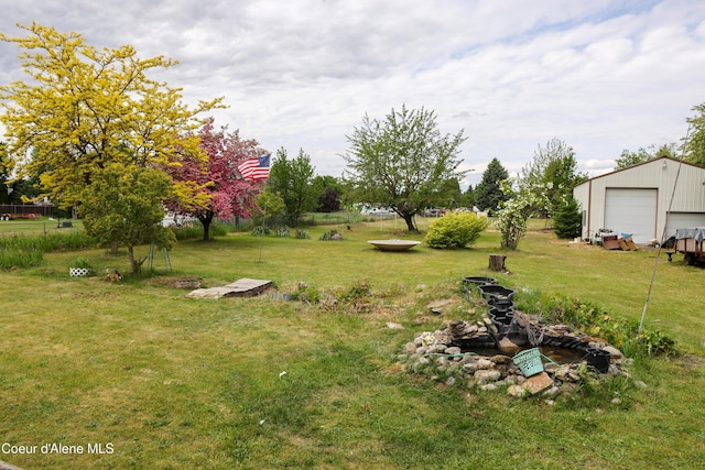 8705 N Ramsey Rd, Hayden, ID 83835 - view of grassy yard with an outdoor structure and a detached garage