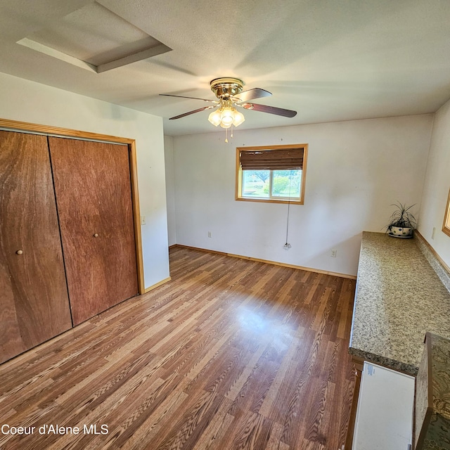 8705 N Ramsey Rd, Hayden, ID 83835 - unfurnished bedroom featuring wood finished floors, baseboards, ceiling fan, and a closet