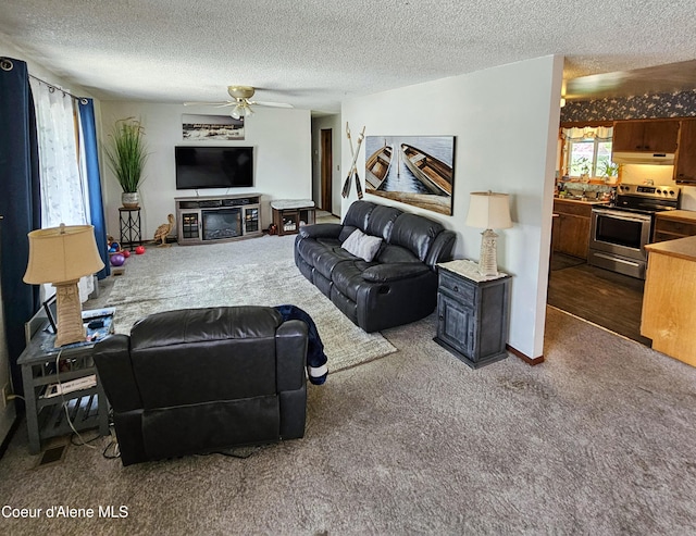 8705 N Ramsey Rd, Hayden, ID 83835 - living room featuring carpet flooring, a textured ceiling, and a ceiling fan