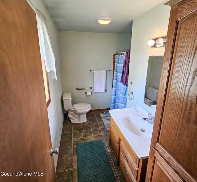 8705 N Ramsey Rd, Hayden, ID 83835 - full bathroom featuring toilet, vanity, tile patterned flooring, and a shower with curtain