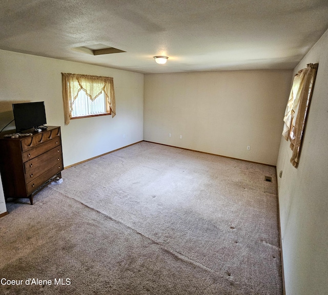 8705 N Ramsey Rd, Hayden, ID 83835 - unfurnished bedroom featuring carpet, a textured ceiling, and baseboards