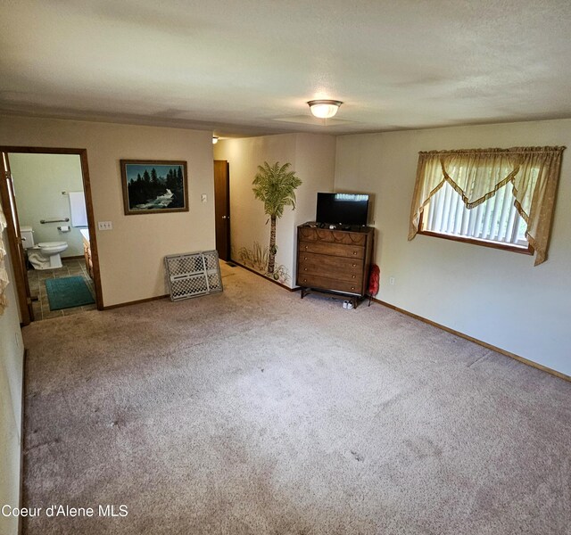 8705 N Ramsey Rd, Hayden, ID 83835 - unfurnished living room featuring carpet floors and baseboards