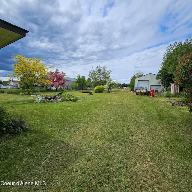 8705 N Ramsey Rd, Hayden, ID 83835 - view of grassy yard featuring a garage and an outdoor structure