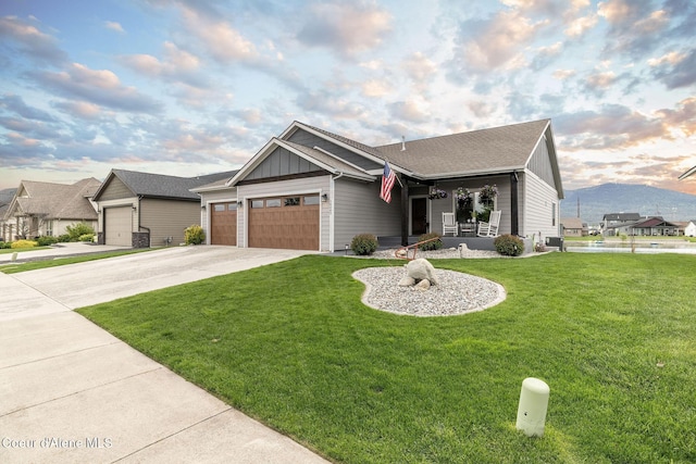 14441 N Pristine Cir, Rathdrum, ID 83858 - view of front facade with board and batten siding, a front lawn, a garage, concrete driveway, and central air condition unit