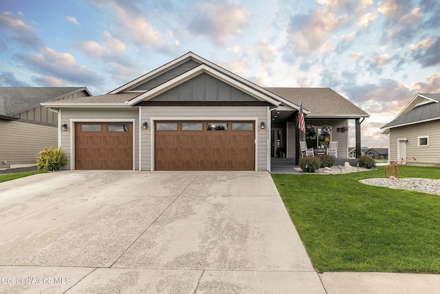 14441 N Pristine Cir, Rathdrum, ID 83858 - view of front of property with a front yard, a garage, concrete driveway, board and batten siding, and covered porch