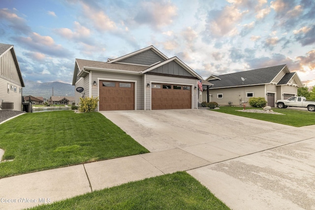 14441 N Pristine Cir, Rathdrum, ID 83858 - craftsman-style home featuring board and batten siding, concrete driveway, a front lawn, and a garage
