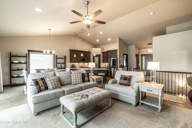 14441 N Pristine Cir, Rathdrum, ID 83858 - living room featuring a chandelier, vaulted ceiling, a ceiling fan, light wood-style flooring, and recessed lighting