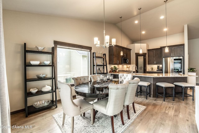 14441 N Pristine Cir, Rathdrum, ID 83858 - dining room featuring light wood finished floors, a chandelier, lofted ceiling, and recessed lighting