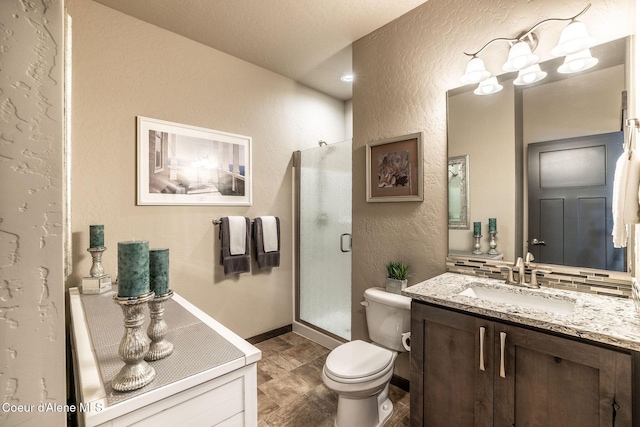 14441 N Pristine Cir, Rathdrum, ID 83858 - full bathroom with a textured wall, vanity, toilet, a stall shower, and decorative backsplash
