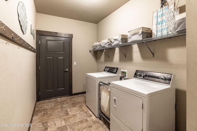 14441 N Pristine Cir, Rathdrum, ID 83858 - laundry area featuring washer and clothes dryer and a textured ceiling