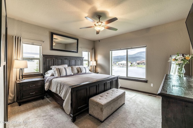 14441 N Pristine Cir, Rathdrum, ID 83858 - carpeted bedroom featuring multiple windows, baseboards, and ceiling fan