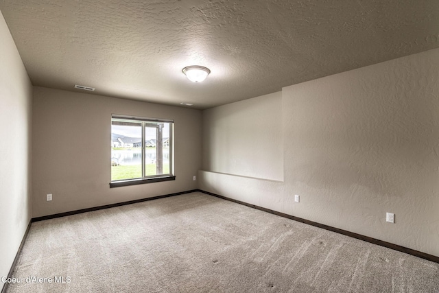14441 N Pristine Cir, Rathdrum, ID 83858 - empty room featuring carpet floors, a textured ceiling, baseboards, and a textured wall
